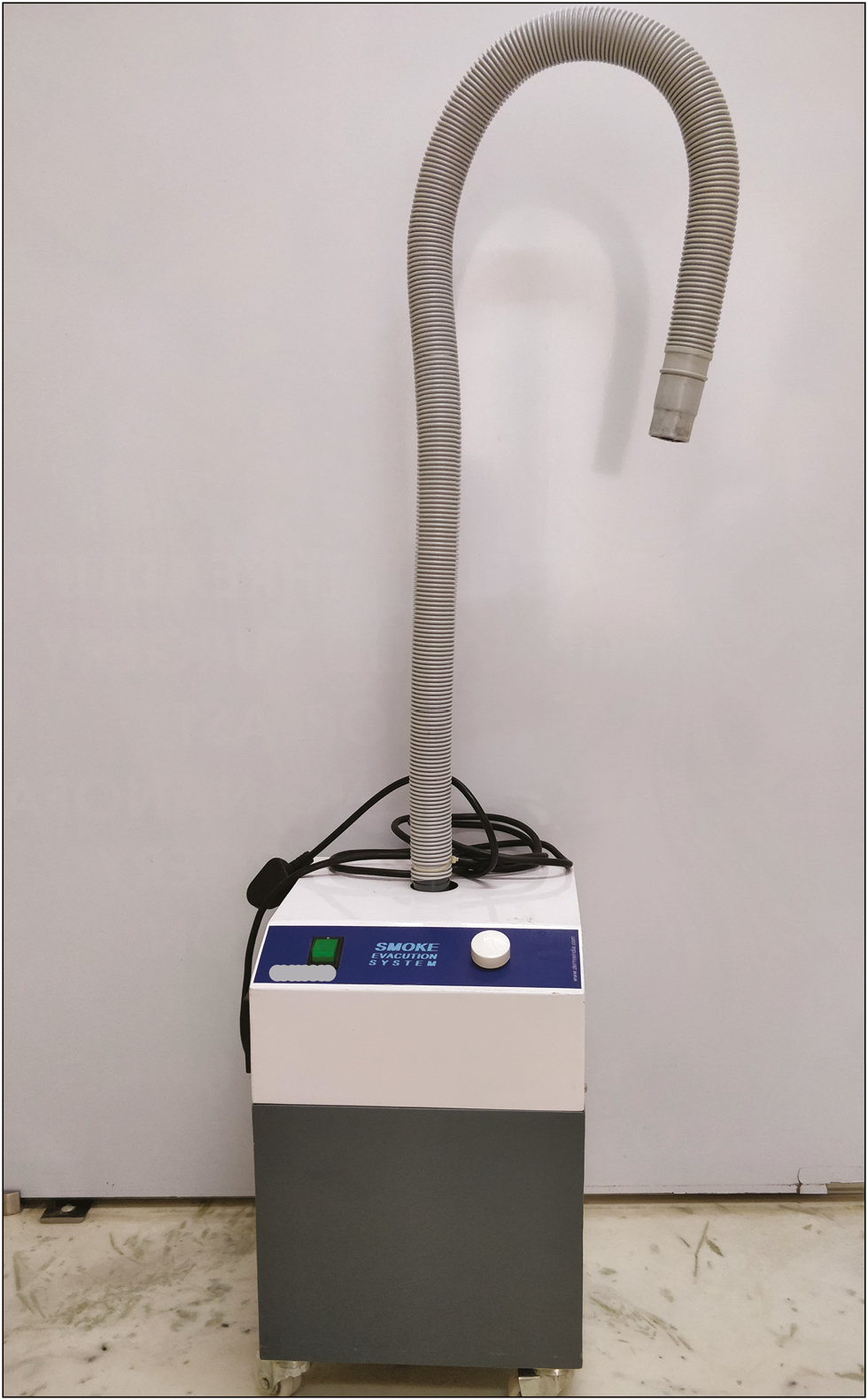 The basic model of a smoke evacuator with an inlet, tubing, and suction unit