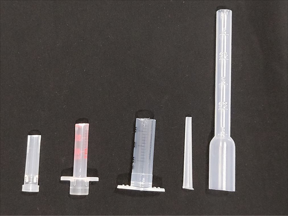 Different options of add-on plastic tip attachments cut at different lengths: needle cap, 1cc and 2.5cc syringe barrels, tapering tip, and proximal portion of plastic dropper