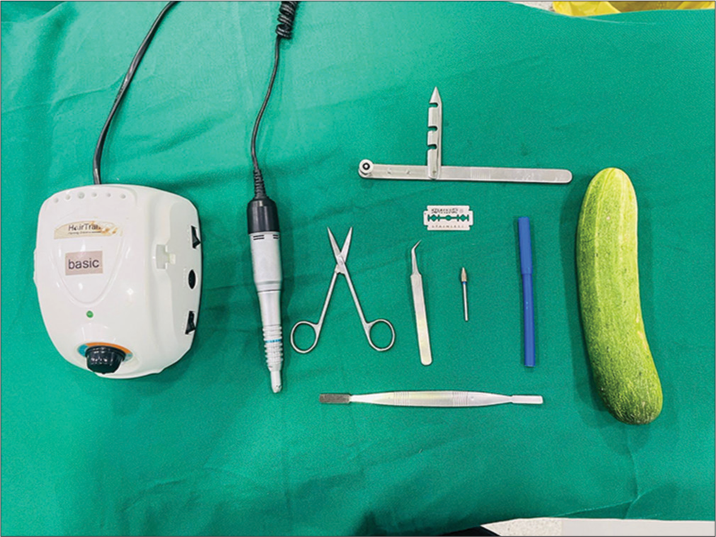 Organic bench model from left to right instruments are motor dermabrader, straight scissors, forceps, burr, skin marker, cucumber, blade, blade holder, and manual dermabrader.